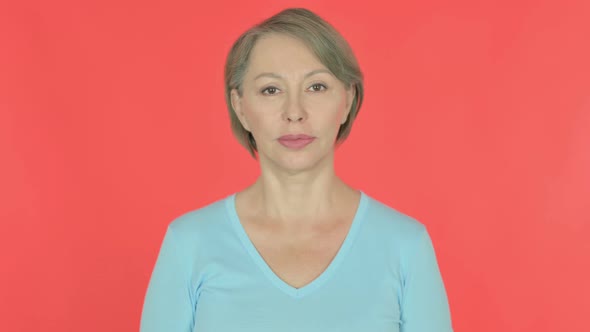 Serious Old Woman on Red Background
