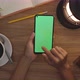 Top View Woman Uses Finger Slide On Green Screen Of Smart Phone. Hobby Table Background. Chroma Key. - VideoHive Item for Sale
