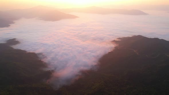 4K aerial view from a drone flying over the valley, fog in the morning.