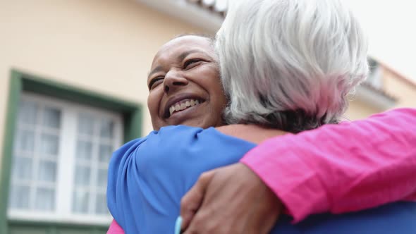 Multiracial Senior Women Hugging Each Other  Elderly Friendship and Love Concept