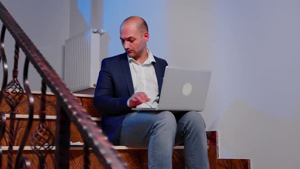 Entrepreneur Checking Documents on Laptop Overworking