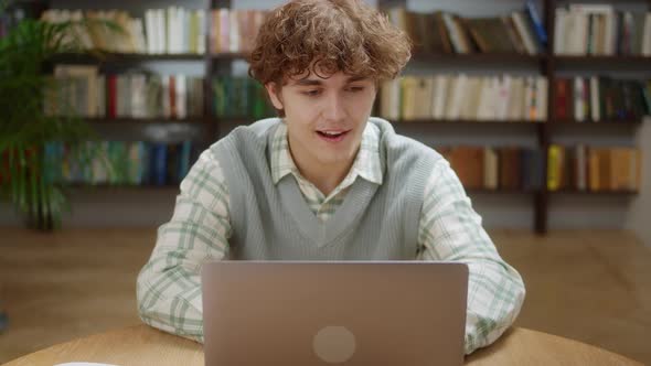 Handsome Curly Student Man Using Laptop Search Information Internet Course Study Online e Learning alt