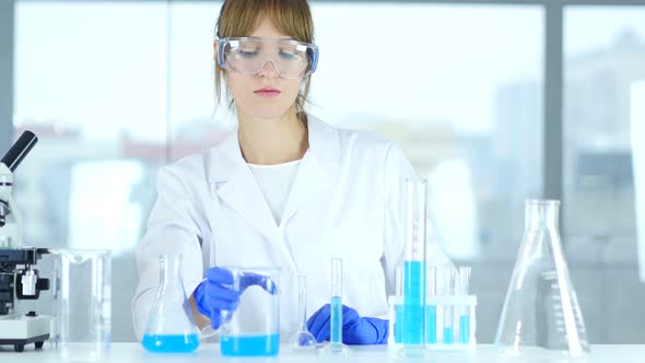 Female Scientist Busy Doing Reaction in Laboratory