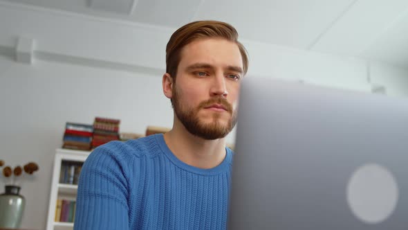 Thinking young teacher working on a laptop at home office