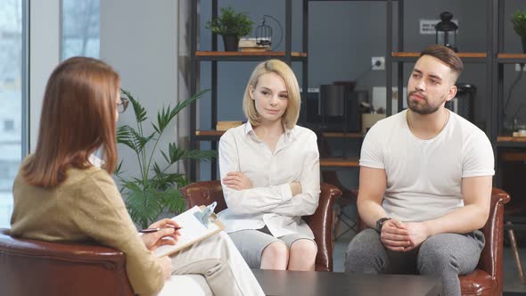 Young Caucasian Couple Offended By Each Other Sit at Consultation with Family Psychologist