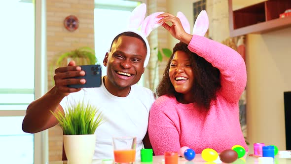 African American Man Preparing for Easter in Apartment Calling to Family By Video Call Phone