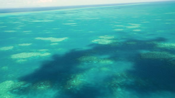 The Great Barrier Reef As Seen From the Airplane. Beautiful Ocean Colors, Aerial View. Slow Motion