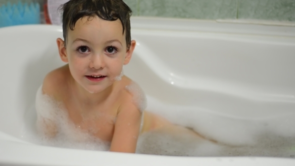 Little Boy Washes Himself in Bath 01