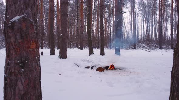 Flying a Drone Over a Campfire in a Winter Forest