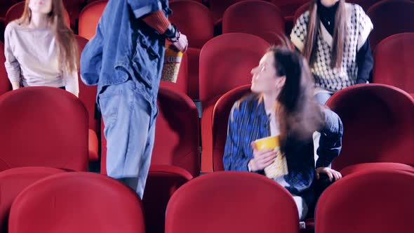 A Group of People are Coming Into a Cinema Hall