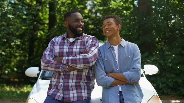 Smiling African Father and Son Looking Camera on Car Background, Trip Adventure