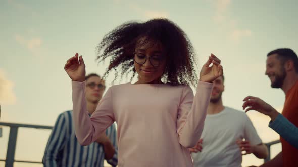 African Girl Dancing with Friends at Party