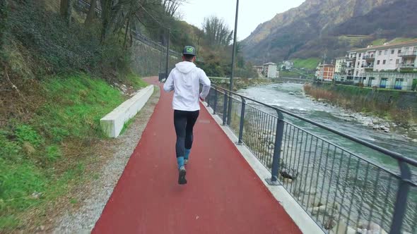 Athlete While Running On Bicycle And Pedestrian Path