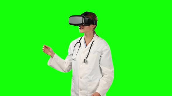 Front view of female doctor using virtual reality with green screen