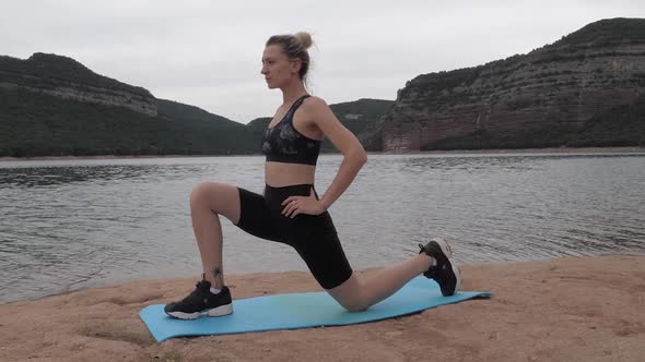 Fit girl stretching left foot with camera slide