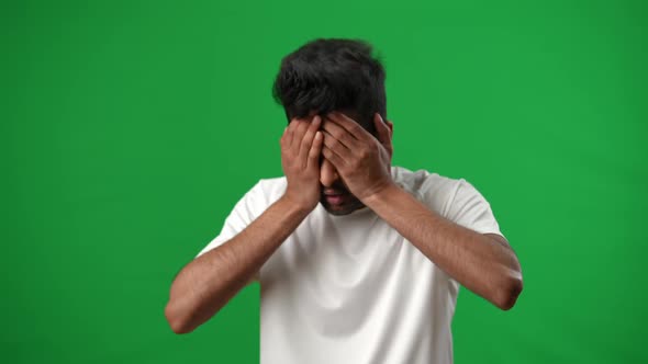 Portrait of Stressed Desperate Middle Eastern Sportsman Looking at Camera Holding Head in Hands