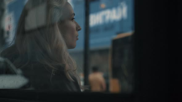 Commuter Woman Waiting Bus on Station in City Landscape Near Road