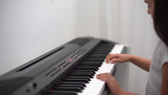 a Little Girl Playing the Piano Synthesizer