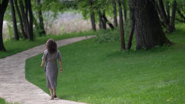 Calm Walk in Park Woman is Strolling Alone on Path in Garden at Summertime