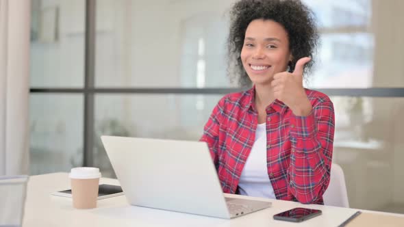 African Woman Showing Thumbs Up Sign While Using Laptop