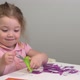 A Little Girl Cuts Scissors with Colored Application Paper. Outdoor Children 's Master Class - VideoHive Item for Sale