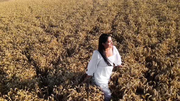 Aerial Footage Woman in White Dress in Wheat Field