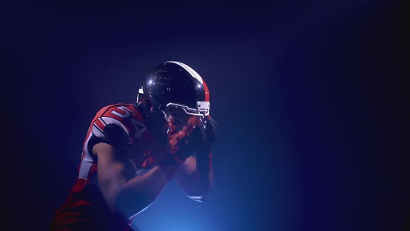 Portrait of Determined Professional American Football Player in Helmet in Bright Stadium