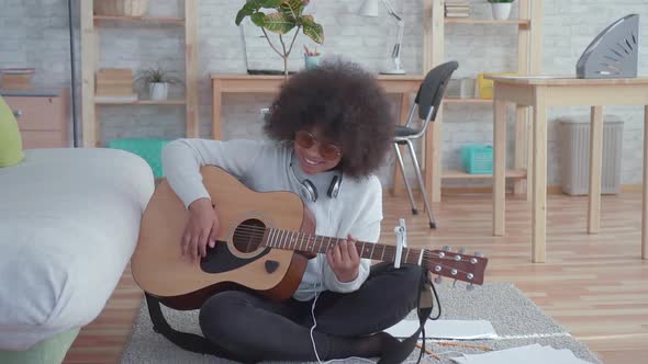 Cheerful African American Woman with an Afro Hairstyle with Acoustic Guitar Slow Mo