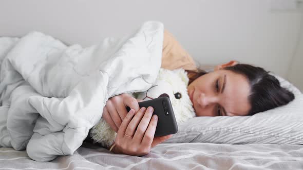 Young Woman Goes to Sleep Phone Addiction Insomnia