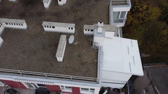 Aerial view of a drone flying over the residential buildings, roof shooting and architecture.