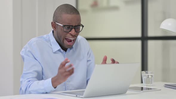 Angry African Man Reacting to Loss at Work Going Crazy