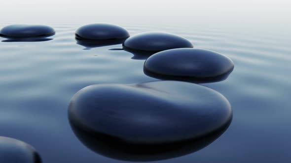 Animation of dark smooth pebbles outstanding over the water level. Loopable. HD