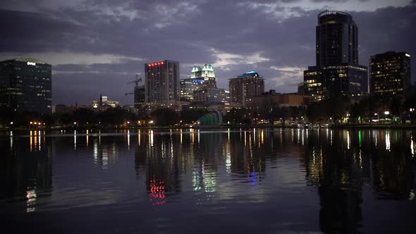 Pan left of buildings and Lake Eola at dusk