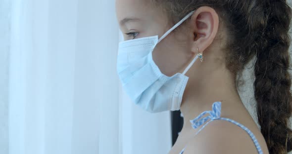 Portrait Little Girl in a Medical Mask