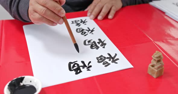 Man write chinese calligraphy for lunar new year