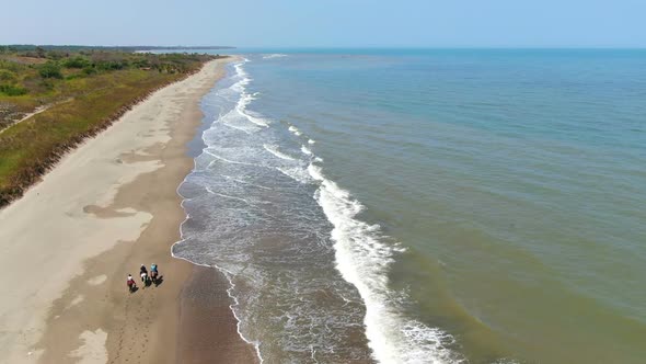 Family Riding Horses on the Seashore