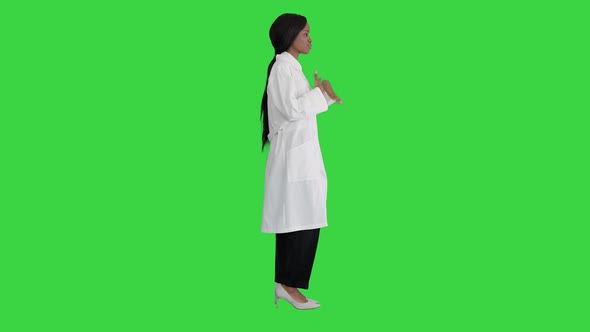 Young African American Female Doctor Talking About Medical Care on a Green Screen, Chroma Key