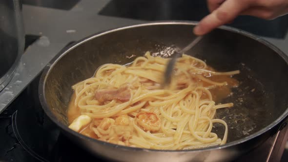 Restaurant Cooking  Chef Cooks Pasta with Bacon in a Frying Pan