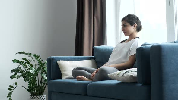 Young Athletic Indian Asian Brunette Woman Doing Yoga Exercise, Looking Away and Taking A Breath