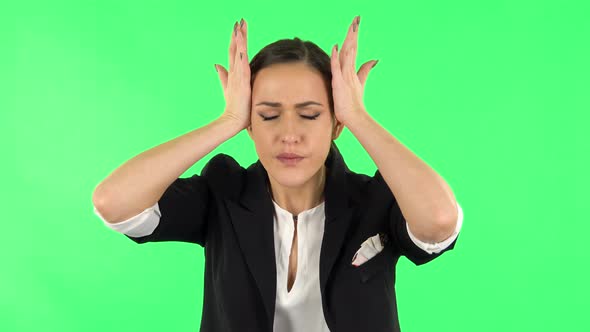 Woman Suffering From Headache From Fatigue. Green Screen