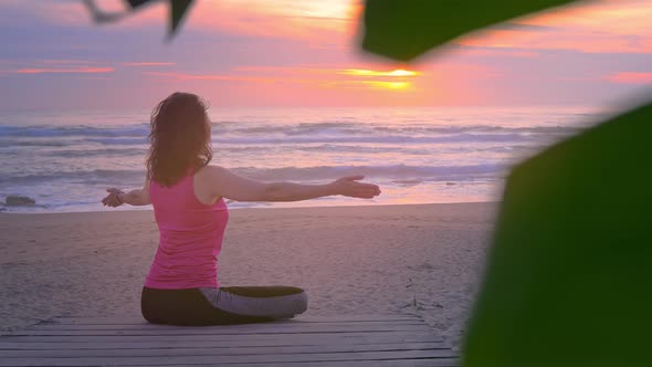 Woman Meditating on Tropical Beach