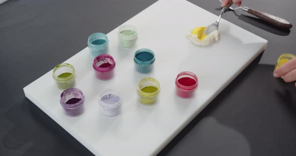 Confectioner Paints Dessert Cream with Different Food Colors