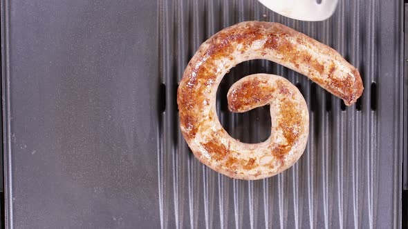 Placing Ring Sausage On Grill