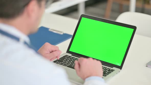 Male Doctor Working on Laptop with Chroma Screen 