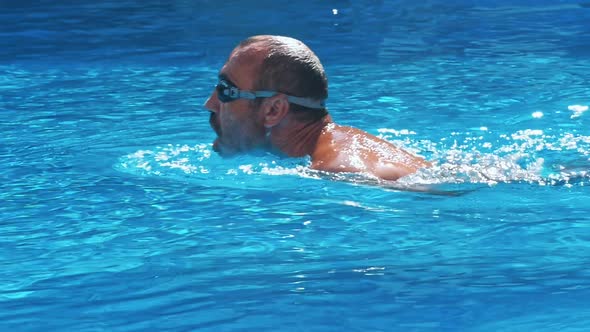 Man Swimming in the Pool