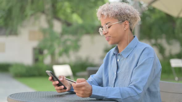 Young African Woman with Unsuccessful Online Payment on Smartphone