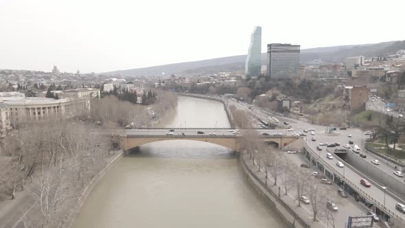 Aerial View of Galaktion Tabidze Bridge over Kura river in the centre of Tbilisi. Georgia 2021 April