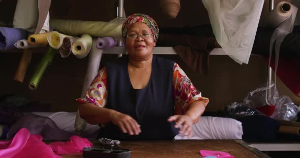 Mixed race woman working at a hat factory