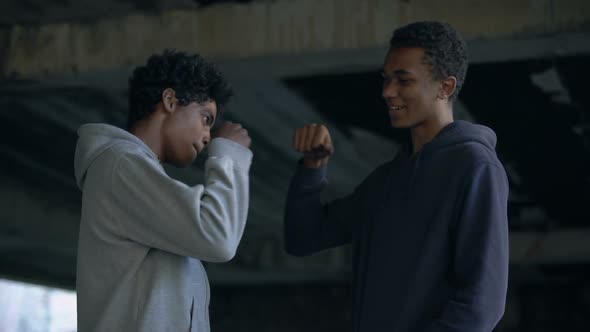 Smiling Black Teens Bumping Fists, Friendship Gesture, Classmates Greeting, Fun