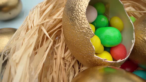 Easter Eggs Painted in Gold Color on Blue Wooden Table Close Up